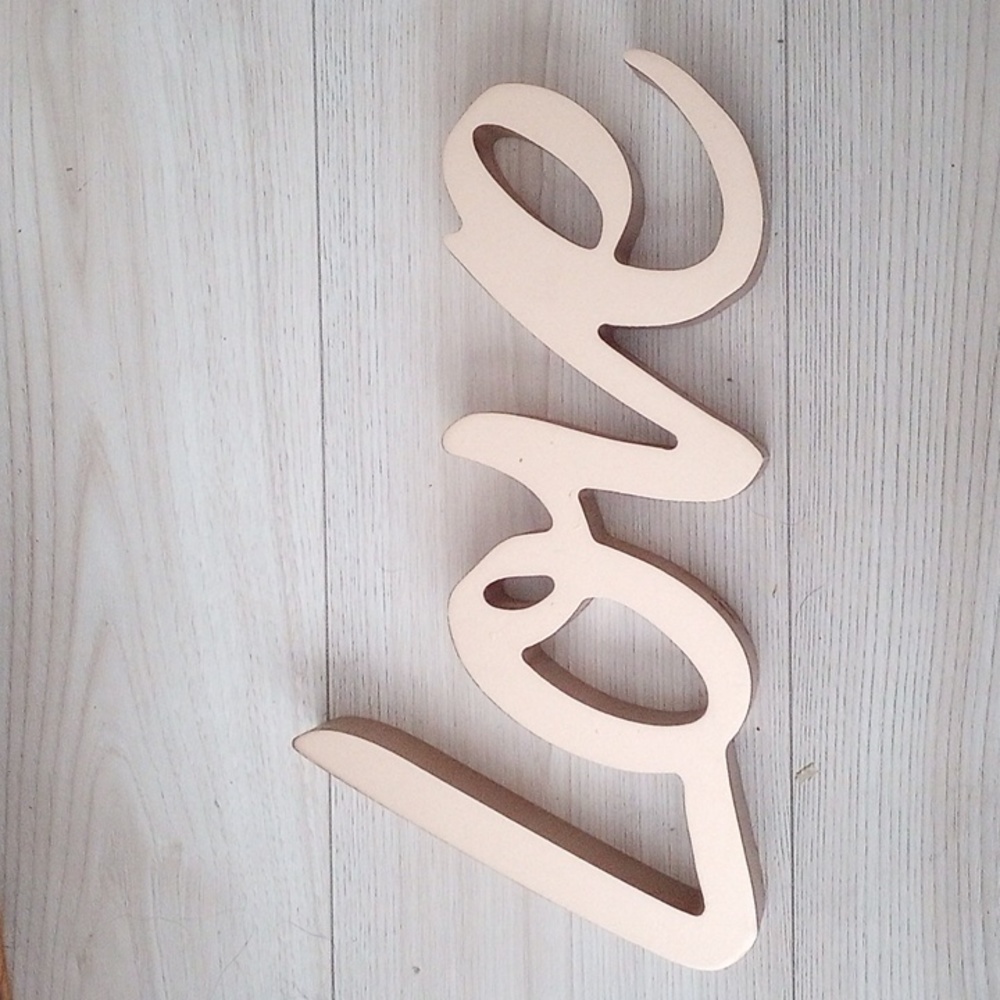 Golden "LOVE" wall decor.